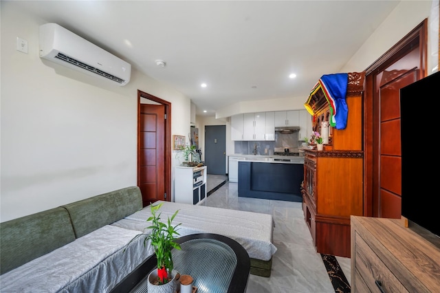 7425 43rd Ave Unit 2A, Elmhurst, NY 11373 - kitchen featuring a wall unit AC, under cabinet range hood, light marble finish flooring, recessed lighting, and white cabinets