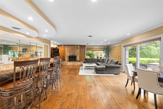 156 Lefferts Rd, Woodmere, NY 11598 - living room featuring light wood-style floors, healthy amount of natural light, crown molding, a stone fireplace, and recessed lighting