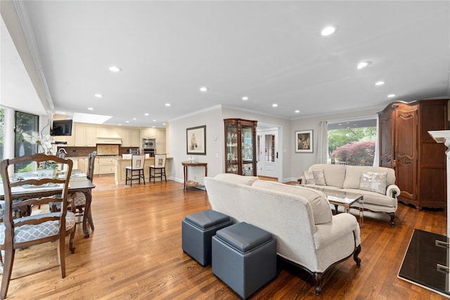 156 Lefferts Rd, Woodmere, NY 11598 - living room featuring ornamental molding, recessed lighting, and light wood-style flooring