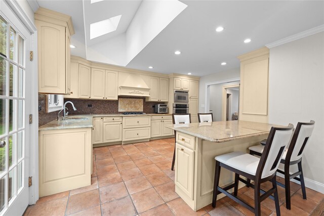 156 Lefferts Rd, Woodmere, NY 11598 - kitchen featuring custom exhaust hood, cream cabinets, oven, gas cooktop, and backsplash