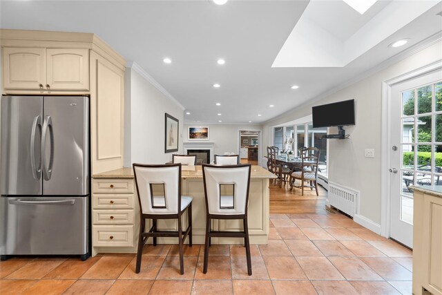 156 Lefferts Rd, Woodmere, NY 11598 - kitchen featuring freestanding refrigerator, cream cabinets, crown molding, radiator, and a peninsula