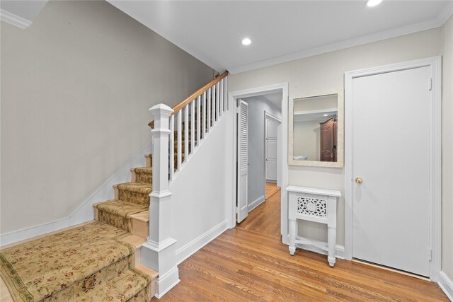 156 Lefferts Rd, Woodmere, NY 11598 - stairs featuring wood finished floors, ornamental molding, and recessed lighting