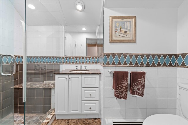 156 Lefferts Rd, Woodmere, NY 11598 - bathroom with vanity, a shower stall, a baseboard radiator, recessed lighting, and tile walls
