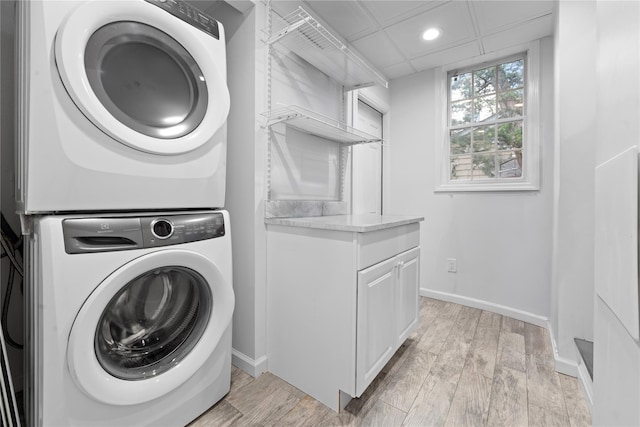 156 Lefferts Rd, Woodmere, NY 11598 - laundry area with stacked washing machine and dryer, recessed lighting, cabinet space, and light wood-style flooring