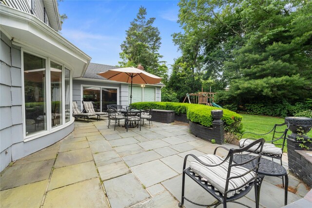 156 Lefferts Rd, Woodmere, NY 11598 - view of patio featuring a playground and outdoor dining space