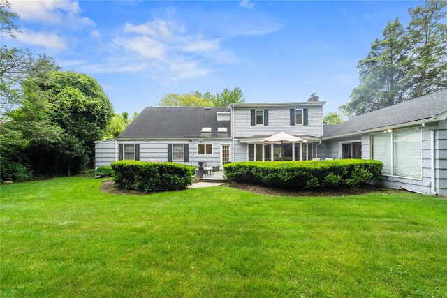 156 Lefferts Rd, Woodmere, NY 11598 - rear view of house featuring a chimney, a lawn, and a patio area