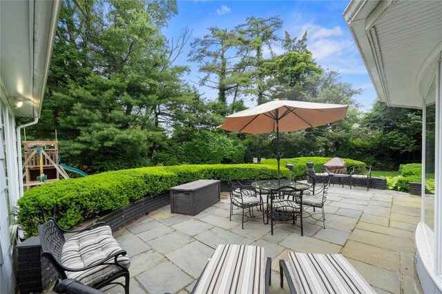 156 Lefferts Rd, Woodmere, NY 11598 - view of patio featuring outdoor dining space and view of wooded area