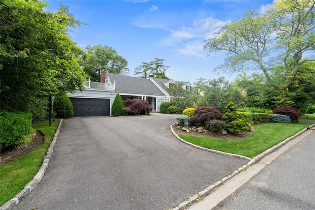 156 Lefferts Rd, Woodmere, NY 11598 - view of front of house with asphalt driveway and a chimney