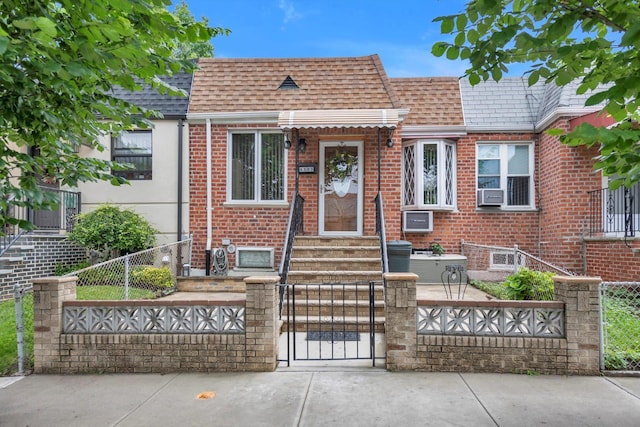 6303 74th St, Middle Village, NY 11379 - view of front facade featuring a fenced front yard, a shingled roof, and brick siding