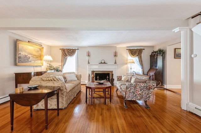 107 S Country Rd, East Patchogue, NY 11772 - living room with plenty of natural light, hardwood / wood-style flooring, baseboard heating, and a fireplace