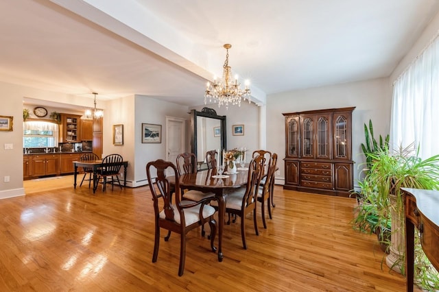 107 S Country Rd, East Patchogue, NY 11772 - dining area featuring a chandelier and light wood-type flooring