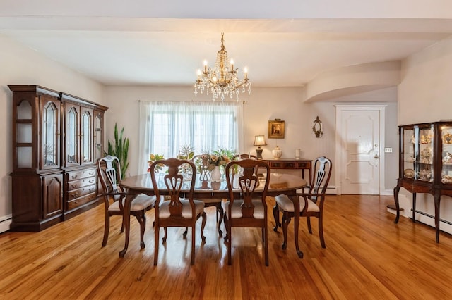 107 S Country Rd, East Patchogue, NY 11772 - dining space with a chandelier and light wood finished floors