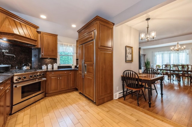 107 S Country Rd, East Patchogue, NY 11772 - kitchen featuring high end appliances, a chandelier, brown cabinets, and recessed lighting