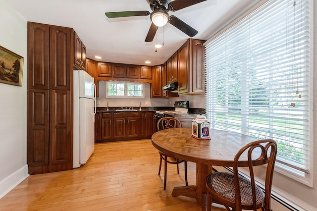 107 S Country Rd, East Patchogue, NY 11772 - kitchen featuring white appliances, under cabinet range hood, dark countertops, light wood finished floors, and recessed lighting