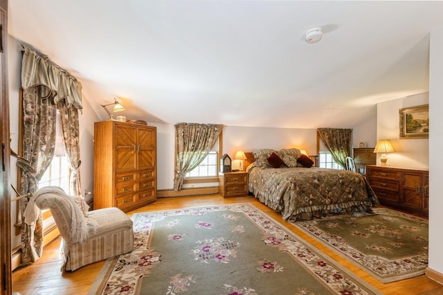 107 S Country Rd, East Patchogue, NY 11772 - bedroom featuring lofted ceiling, wood finished floors, and a baseboard radiator