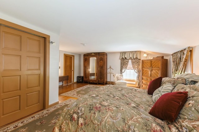 107 S Country Rd, East Patchogue, NY 11772 - bedroom featuring wood finished floors and vaulted ceiling