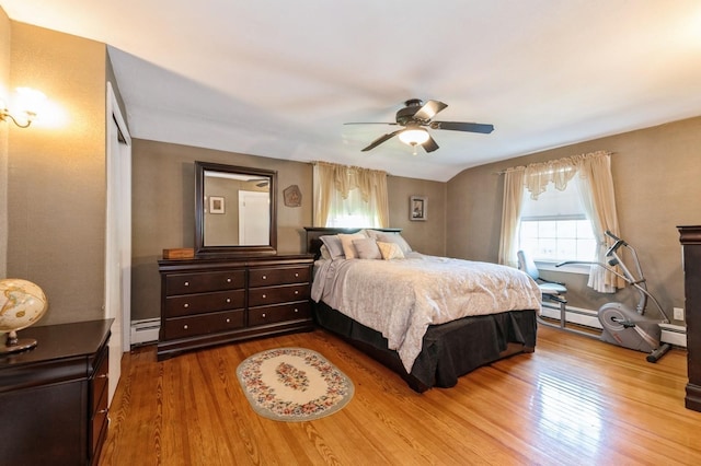 107 S Country Rd, East Patchogue, NY 11772 - bedroom featuring wood finished floors, a baseboard heating unit, a baseboard radiator, and a ceiling fan