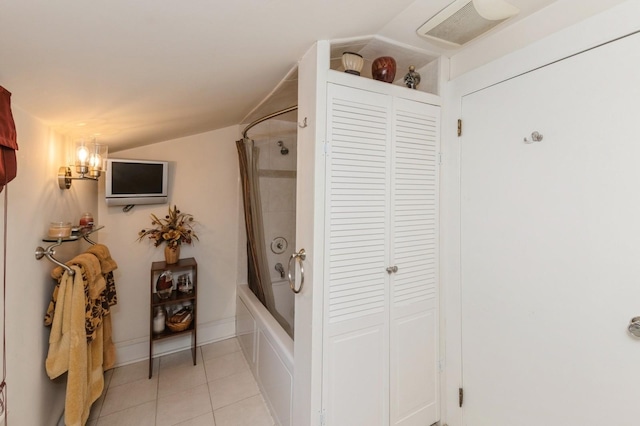 107 S Country Rd, East Patchogue, NY 11772 - bathroom featuring a closet, shower / bathtub combination with curtain, tile patterned flooring, and lofted ceiling