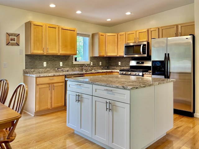 167 Benner Rd, Red Hook, NY 12571 - kitchen featuring stainless steel appliances, light wood-style floors, decorative backsplash, a kitchen island, and recessed lighting