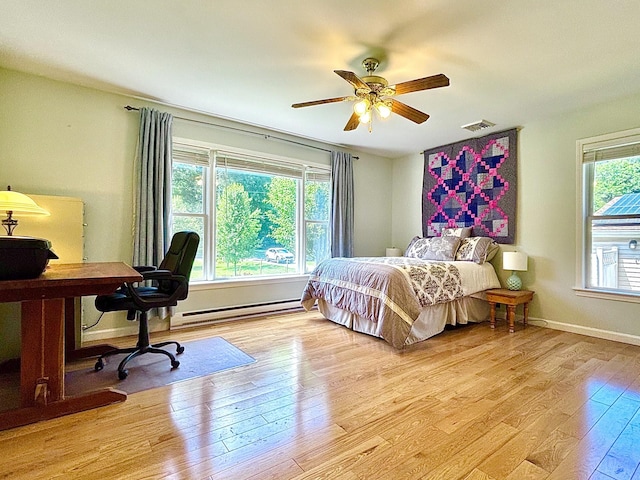 167 Benner Rd, Red Hook, NY 12571 - bedroom featuring a baseboard radiator, light wood finished floors, a desk, and ceiling fan