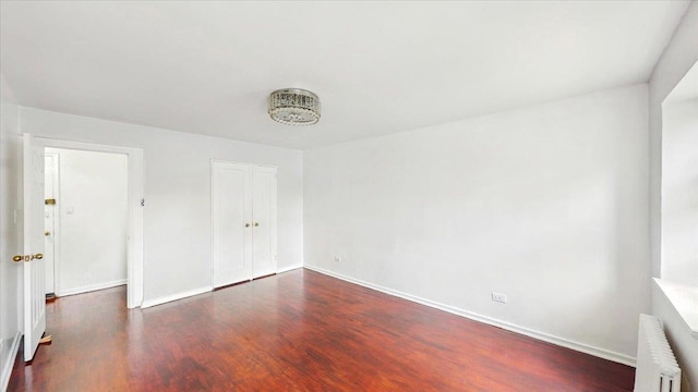 144-37 79th Ave Unit 1R, Kew Garden Hills, NY 11367 - unfurnished bedroom with radiator, wood finished floors, and a closet