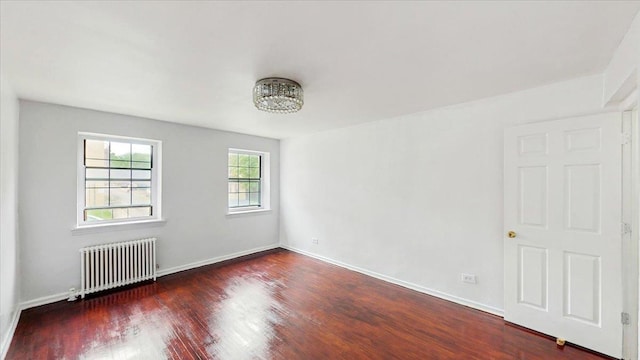 144-37 79th Ave Unit 1R, Kew Garden Hills, NY 11367 - spare room featuring radiator heating unit and wood finished floors