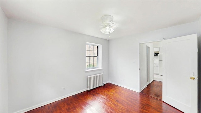144-37 79th Ave Unit 1R, Kew Garden Hills, NY 11367 - empty room featuring radiator, wood finished floors, and a ceiling fan
