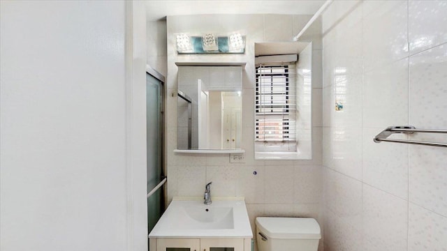 144-37 79th Ave Unit 1R, Kew Garden Hills, NY 11367 - full bathroom with vanity, a shower with shower door, and tile walls