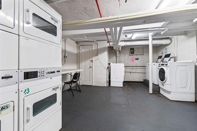144-37 79th Ave Unit 1R, Kew Garden Hills, NY 11367 - garage featuring stacked washer / drying machine, washer and clothes dryer, and electric panel