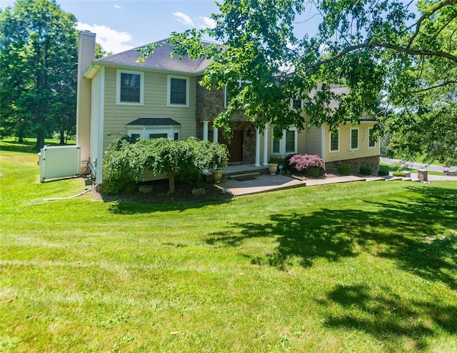 10 Von Trapp Ct, Washingtonville, NY 10992 - view of front of property featuring a chimney, a front yard, and stone siding