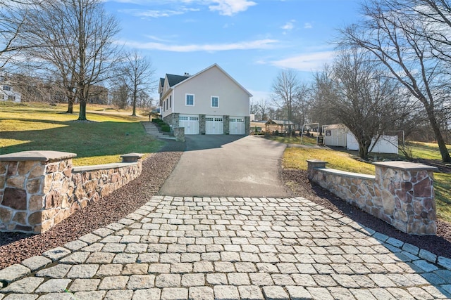 10 Von Trapp Ct, Washingtonville, NY 10992 - view of property exterior featuring asphalt driveway, an attached garage, and a lawn