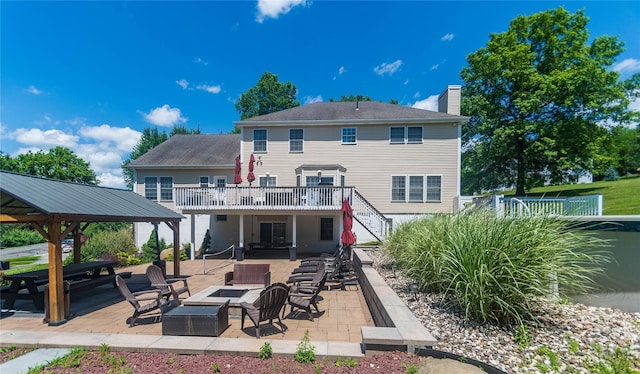 10 Von Trapp Ct, Washingtonville, NY 10992 - back of property with stairway, a chimney, a patio, a gazebo, and an outdoor living space with a fire pit
