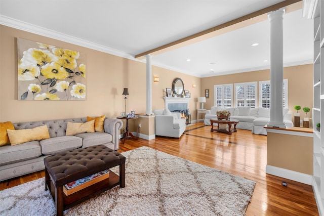 10 Von Trapp Ct, Washingtonville, NY 10992 - living area with decorative columns, ornamental molding, wood finished floors, recessed lighting, and a warm lit fireplace