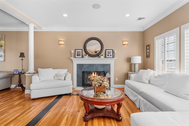 10 Von Trapp Ct, Washingtonville, NY 10992 - living area featuring decorative columns, wood finished floors, ornamental molding, a fireplace, and recessed lighting