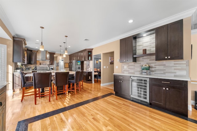 10 Von Trapp Ct, Washingtonville, NY 10992 - kitchen featuring beverage cooler, backsplash, wall chimney range hood, dark brown cabinetry, and recessed lighting
