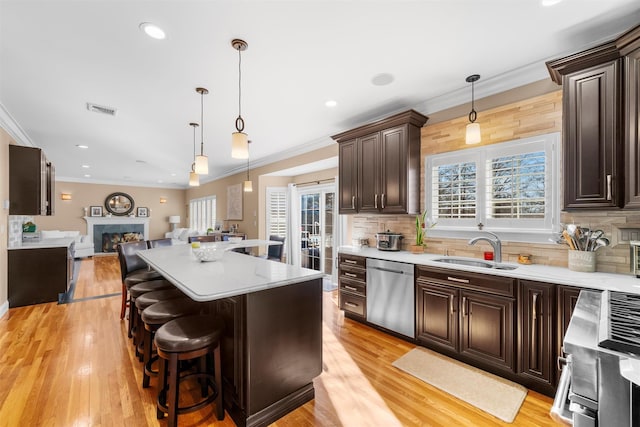 10 Von Trapp Ct, Washingtonville, NY 10992 - kitchen with stainless steel dishwasher, range, dark brown cabinets, open floor plan, and a premium fireplace