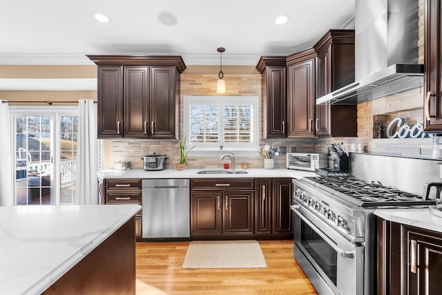 10 Von Trapp Ct, Washingtonville, NY 10992 - kitchen featuring stainless steel appliances, wall chimney exhaust hood, plenty of natural light, dark brown cabinetry, and recessed lighting
