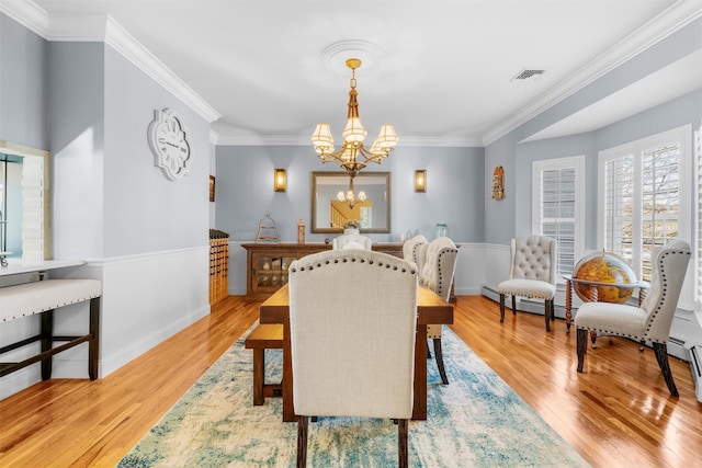 10 Von Trapp Ct, Washingtonville, NY 10992 - dining room featuring a chandelier, light wood-style floors, ornamental molding, and baseboard heating