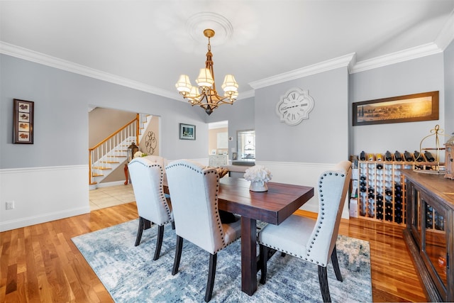 10 Von Trapp Ct, Washingtonville, NY 10992 - dining space with stairs, crown molding, light wood-style flooring, and a chandelier