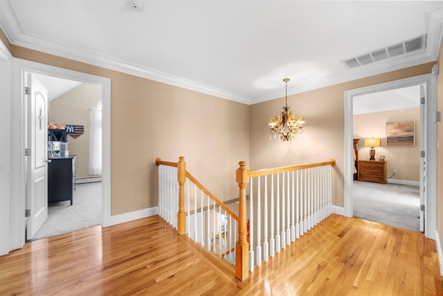 10 Von Trapp Ct, Washingtonville, NY 10992 - corridor with an upstairs landing, ornamental molding, a chandelier, wood finished floors, and a baseboard heating unit