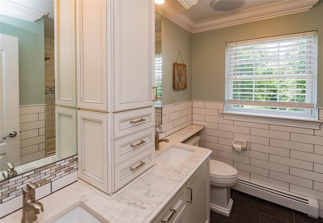 10 Von Trapp Ct, Washingtonville, NY 10992 - bathroom with a baseboard radiator, tile walls, ornamental molding, tile patterned flooring, and vanity