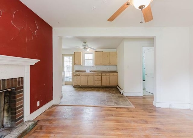 8 Gary Dr, Hyde Park, NY 12538 - kitchen with ceiling fan, a baseboard radiator, light wood-style floors, and a fireplace