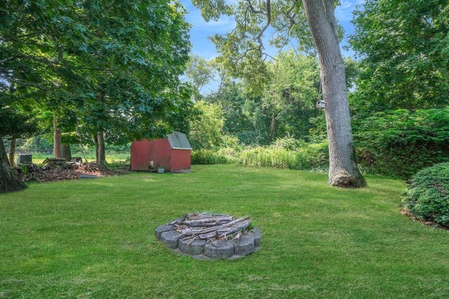 126 Carman St, Patchogue, NY 11772 - view of grassy yard with a shed and an outdoor fire pit