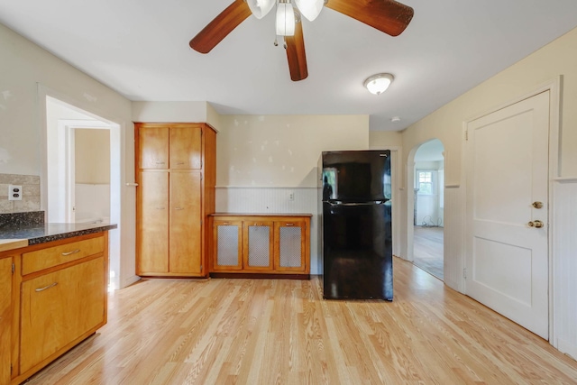 126 Carman St, Patchogue, NY 11772 - kitchen featuring freestanding refrigerator, arched walkways, a ceiling fan, light wood finished floors, and brown cabinetry