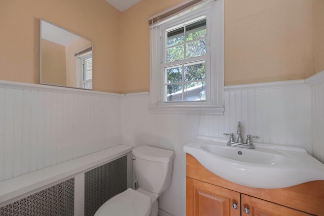 126 Carman St, Patchogue, NY 11772 - half bath featuring wainscoting, radiator, and vanity
