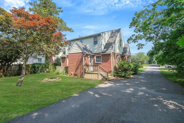 126 Carman St, Patchogue, NY 11772 - view of property exterior with brick siding and asphalt driveway