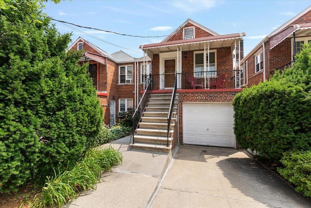 1528 Rhinelander Ave, Bronx, NY 10461 - view of front facade with brick siding, concrete driveway, covered porch, a garage, and stairs