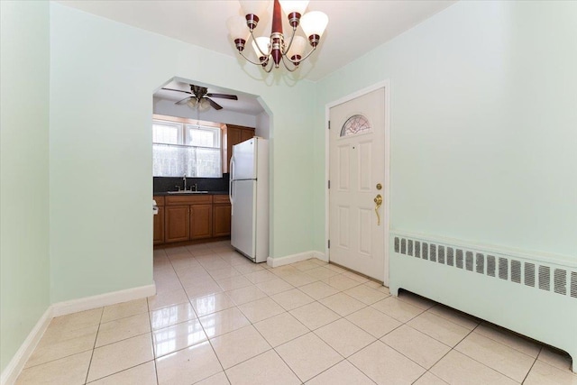 1528 Rhinelander Ave, Bronx, NY 10461 - unfurnished dining area featuring radiator heating unit, a chandelier, light tile patterned floors, and ceiling fan