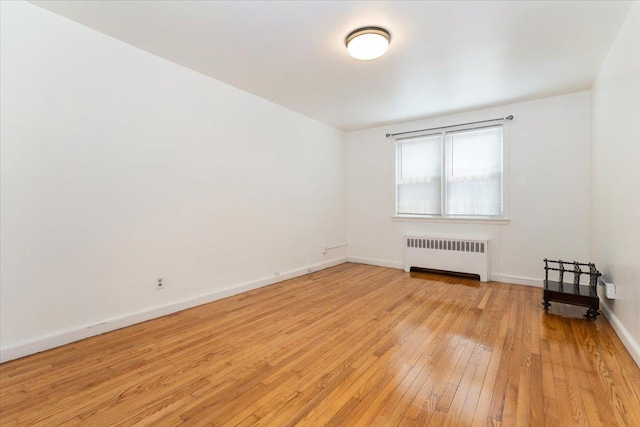 1528 Rhinelander Ave, Bronx, NY 10461 - empty room with radiator heating unit and light wood finished floors