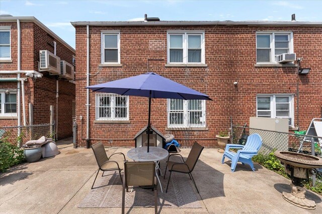 1528 Rhinelander Ave, Bronx, NY 10461 - back of house with brick siding, a patio, and outdoor dining space